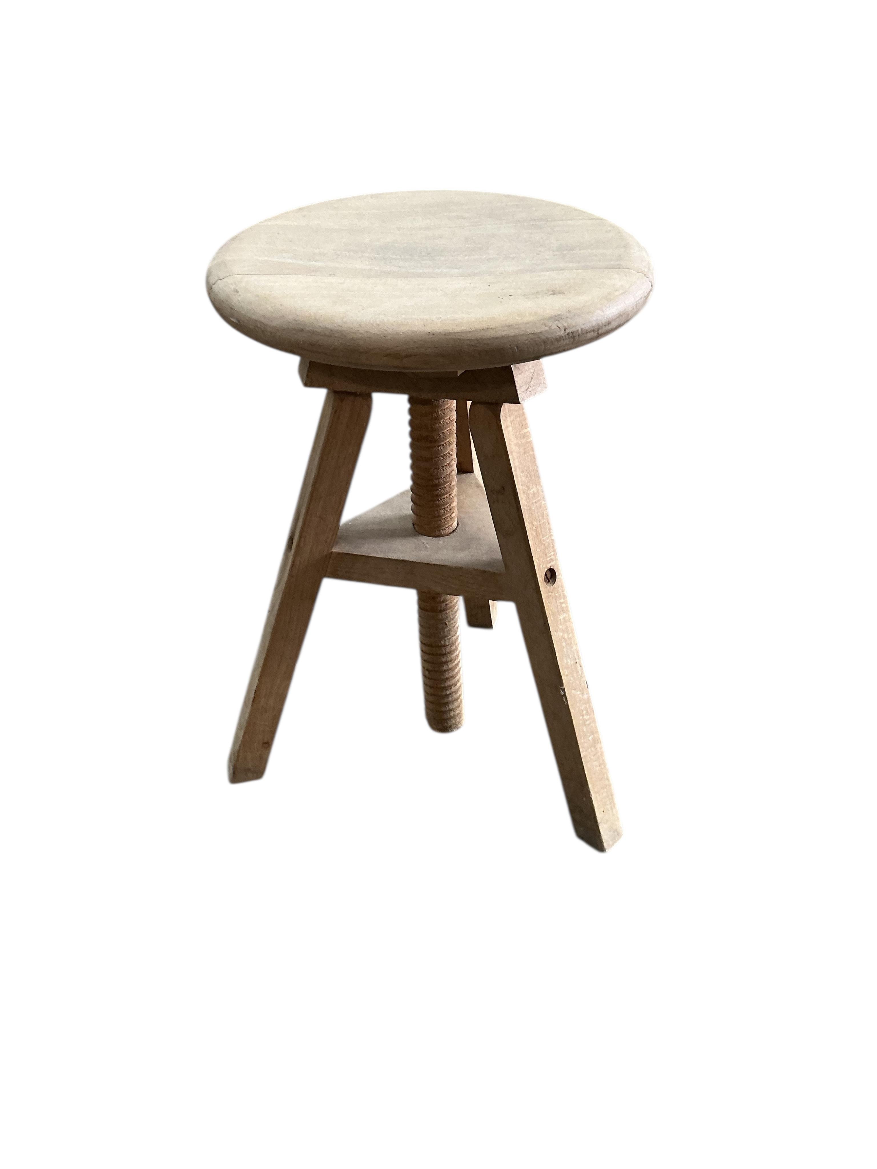 A circular beech revolving adjustable stool